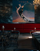 Vogue poster and red seating in the lounge